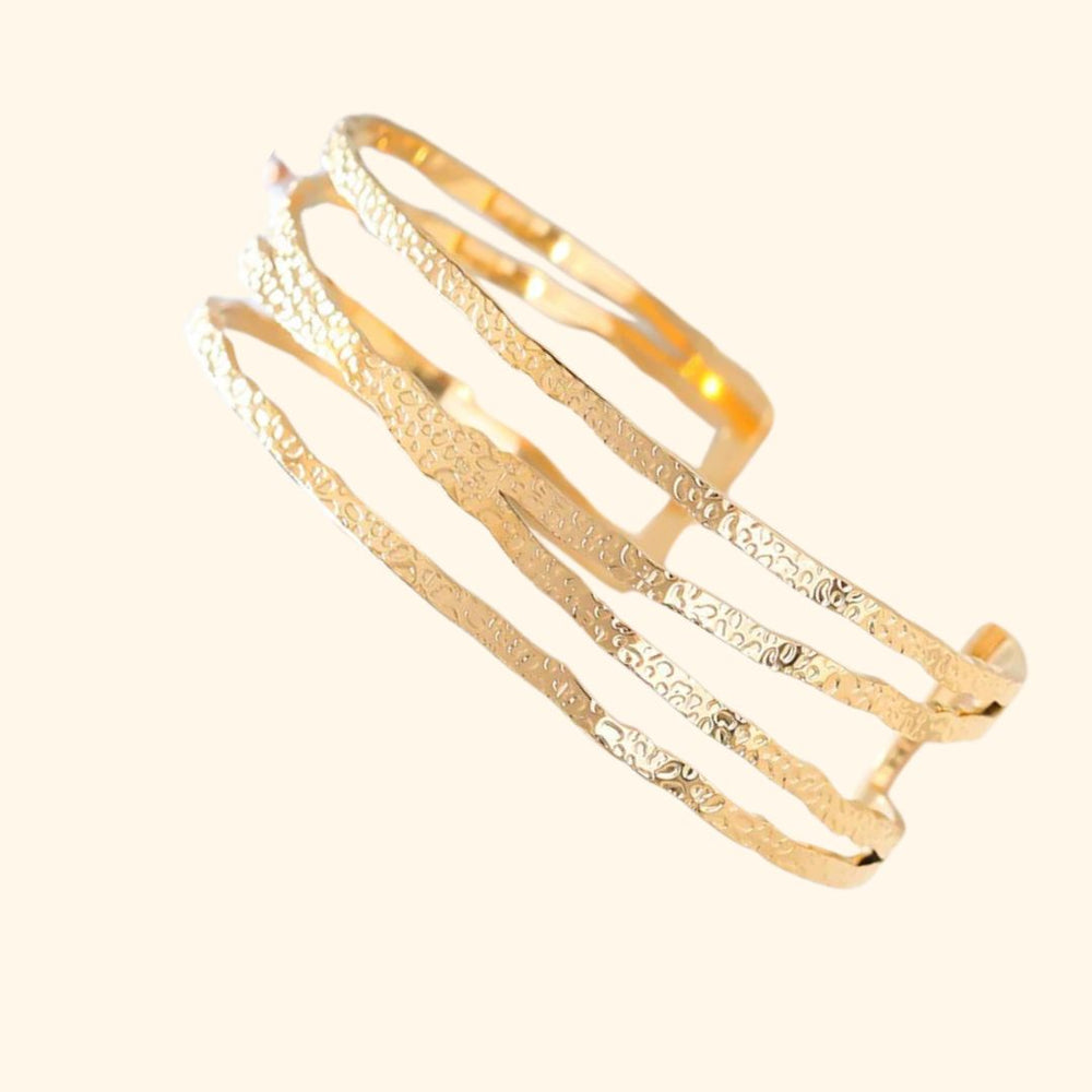 Bracelet manchette acier inoxydable doré martelé croisé 